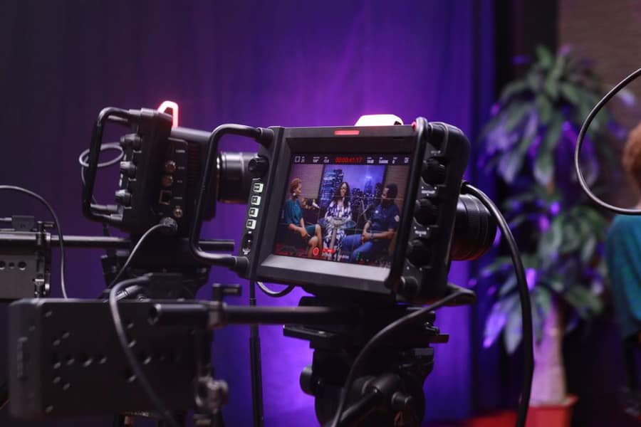 A video camera recording a studio interview